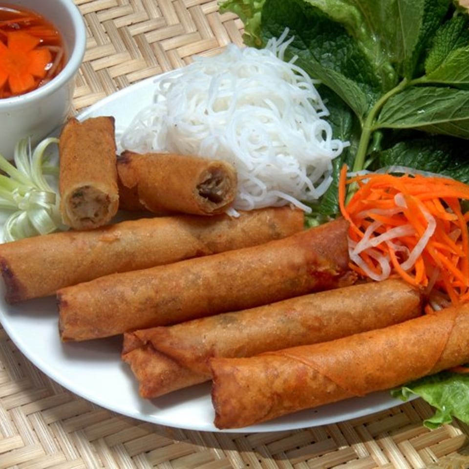 Crispy Vietnamese spring rolls with vermicelli noodles, fresh herbs, pickled carrots, and dipping sauce.